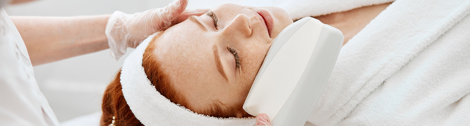 Ultrasound infrared cosmetology procedure for face, top view, beauty treatment.